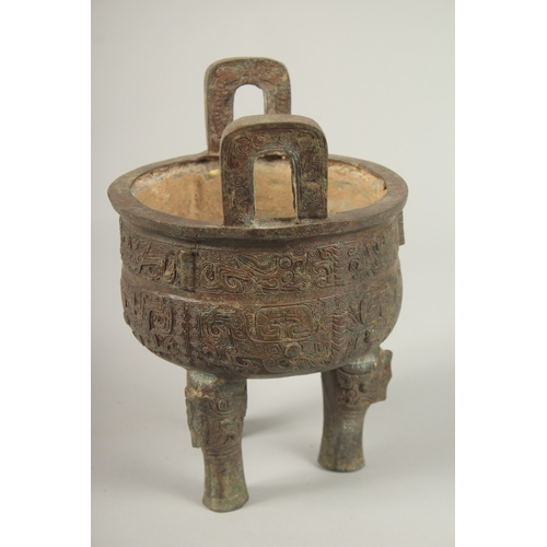 91 - AN ARCHAIC BRONZE TWO HANDLED CIRCULAR CENSER. 23cms high x 16cms wide.