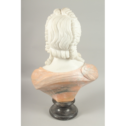 18 - A GOOD CARVED TWO COLOUR MARBLE BUST OF A LADY, on a circular base. 64cm high.