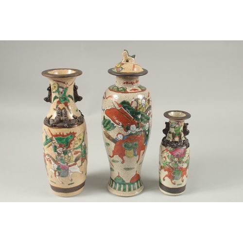 1002 - A COLLECTION THREE CHINESE FAMILLE ROSE CRACKLE GLAZE VASES, each painted with warriors on horseback... 