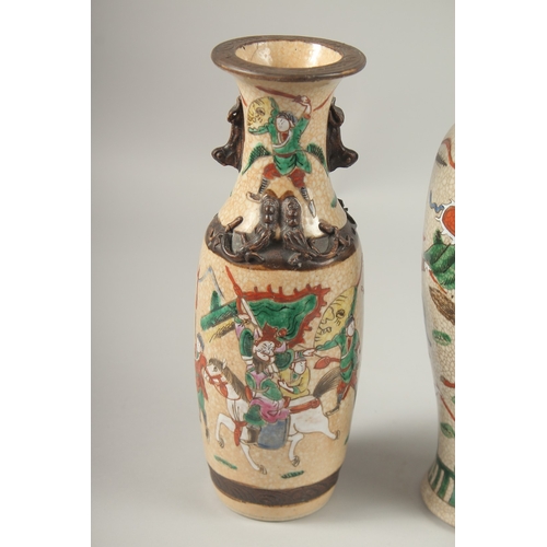 1002 - A COLLECTION THREE CHINESE FAMILLE ROSE CRACKLE GLAZE VASES, each painted with warriors on horseback... 