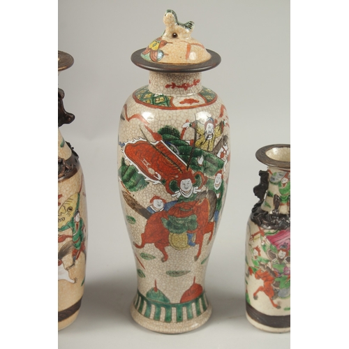 1002 - A COLLECTION THREE CHINESE FAMILLE ROSE CRACKLE GLAZE VASES, each painted with warriors on horseback... 