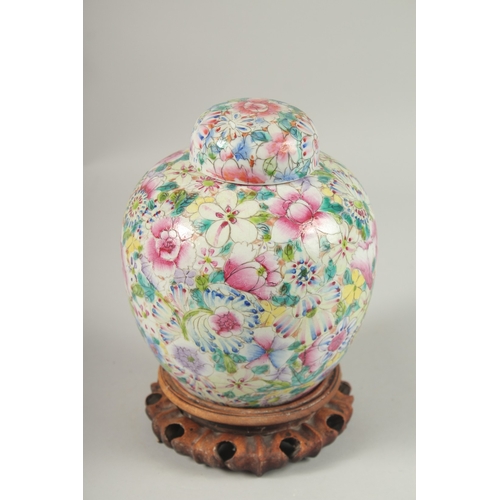 1003 - A CHINESE MILLEFLEURS FAMILLE ROSE PORCELAIN JAR AND COVER, base with character mark, 20cm high.