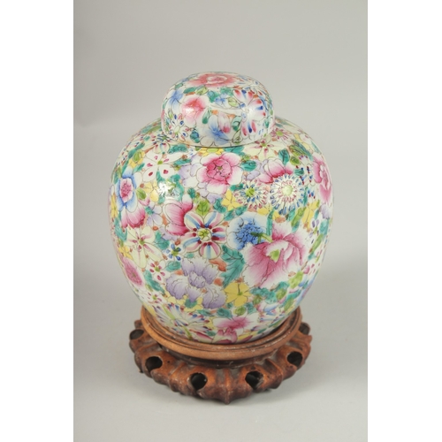 1003 - A CHINESE MILLEFLEURS FAMILLE ROSE PORCELAIN JAR AND COVER, base with character mark, 20cm high.