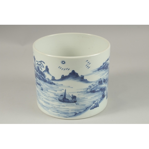 1013 - A LARGE CHINESE BLUE AND WHITE PORCELAIN CYLINDRICAL BRUSH POT, painted with a continuous landscape ... 