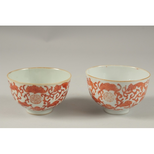 1016 - A PAIR OF CHINESE COPPER RED AND WHITE PORCELAIN BOWLS, with bats and longevity symbols, 10cm diamet... 