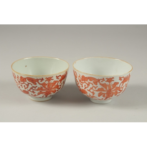 1016 - A PAIR OF CHINESE COPPER RED AND WHITE PORCELAIN BOWLS, with bats and longevity symbols, 10cm diamet... 