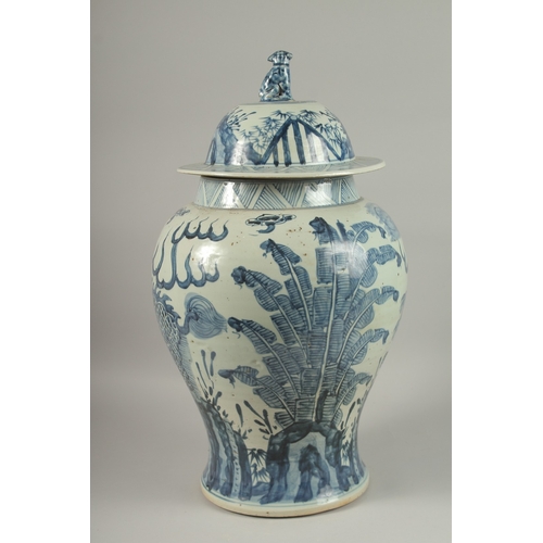 1017 - A LARGE CHINESE BLUE AND WHITE PORCELAIN BALUSTER FORM URN AND COVER, painted with mythical beasts a... 