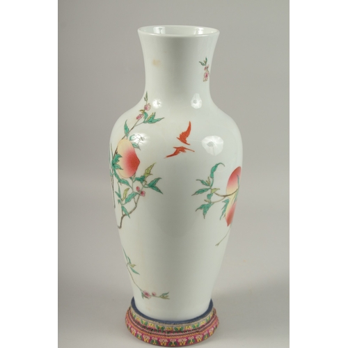 1018 - A LARGE CHINESE FAMILLE ROSE PORCELAIN PEACH VASE, with stand, vase 39.5cm high.