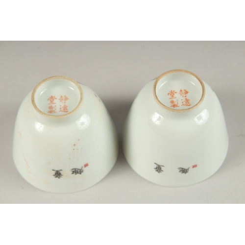 1019 - A PAIR OF CHINESE POLYCHROME PORCELAIN TEA CUPS, painted with boys playing, the base with red charac... 