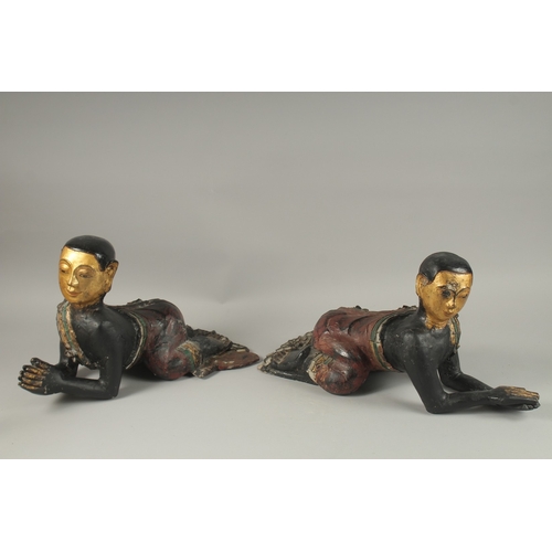 1023 - A PAIR OF LARGE CARVED AND LACQUERED WOOD CRAWLING BUDDHAS, each with gilded faces and coloured glas... 