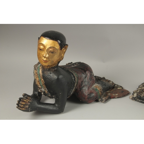 1023 - A PAIR OF LARGE CARVED AND LACQUERED WOOD CRAWLING BUDDHAS, each with gilded faces and coloured glas... 