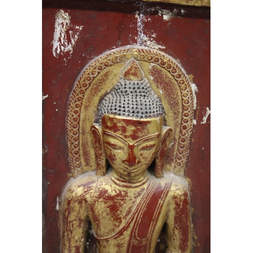 1024 - THREE LARGE RELIEF CARVED WOODEN BUDDHISTIC PANELS, each panel gilded and lacquered in red with carv... 