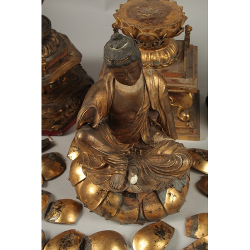 1025 - A COLLECTION OF THREE GILDED CARVED WOOD BUDDHAS AND ACCESSORIES, including stands and various piece... 