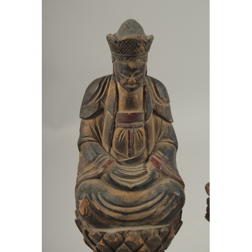 1026 - A CHINESE CARVED WOOD BUDDHA SEATED UPON A LOTUS BASE, with traces of gilt, 31cm high, together with... 