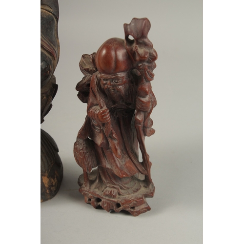 1026 - A CHINESE CARVED WOOD BUDDHA SEATED UPON A LOTUS BASE, with traces of gilt, 31cm high, together with... 