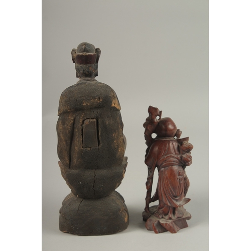 1026 - A CHINESE CARVED WOOD BUDDHA SEATED UPON A LOTUS BASE, with traces of gilt, 31cm high, together with... 