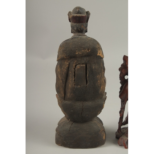 1026 - A CHINESE CARVED WOOD BUDDHA SEATED UPON A LOTUS BASE, with traces of gilt, 31cm high, together with... 