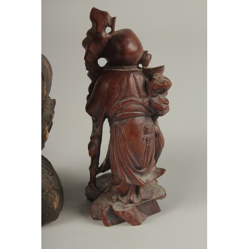 1026 - A CHINESE CARVED WOOD BUDDHA SEATED UPON A LOTUS BASE, with traces of gilt, 31cm high, together with... 