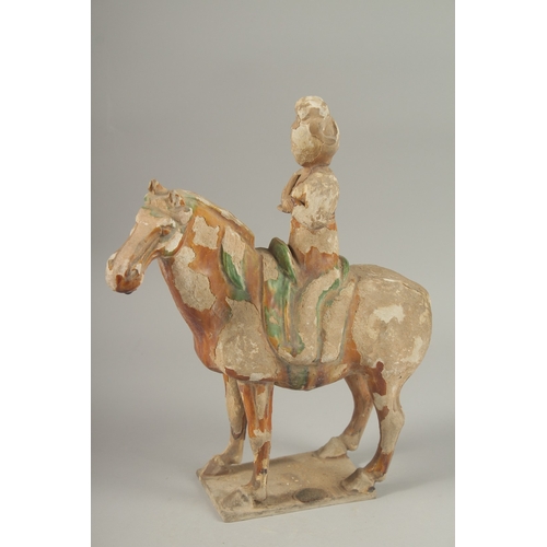 1039 - A TANG POTTERY HORSE AND RIDER, 32cm high.