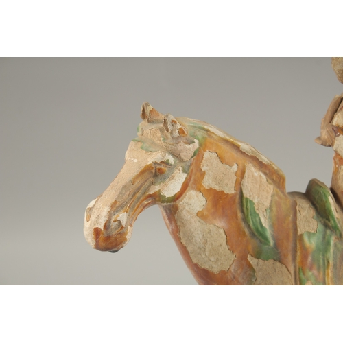 1039 - A TANG POTTERY HORSE AND RIDER, 32cm high.