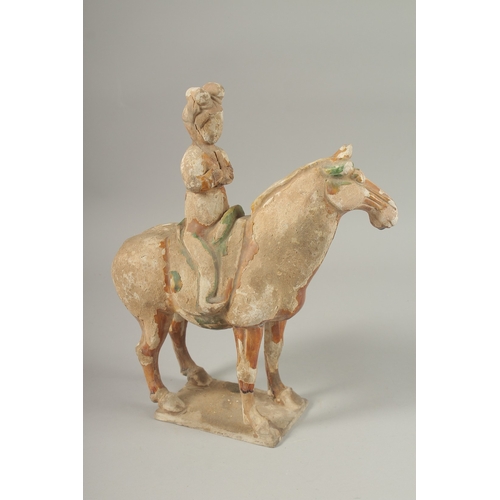 1039 - A TANG POTTERY HORSE AND RIDER, 32cm high.