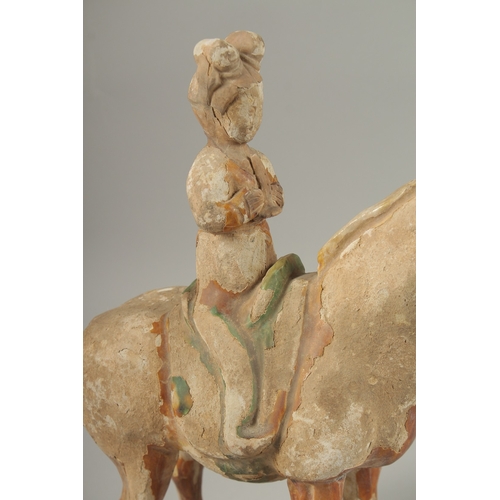 1039 - A TANG POTTERY HORSE AND RIDER, 32cm high.