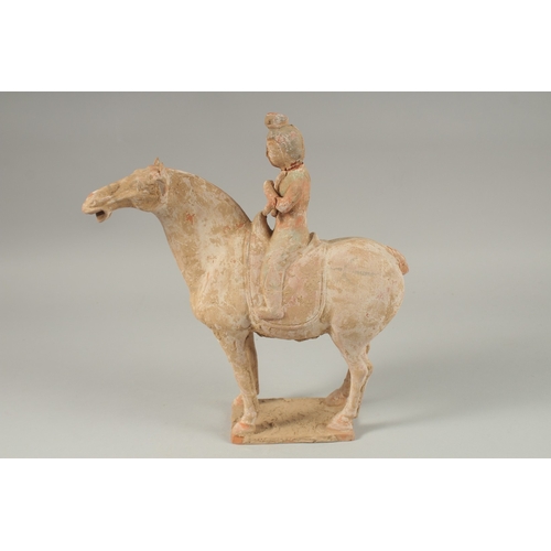 1040 - A TANG POTTERY HORSE AND RIDER, 32cm high.