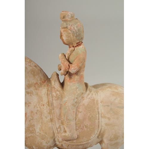 1040 - A TANG POTTERY HORSE AND RIDER, 32cm high.