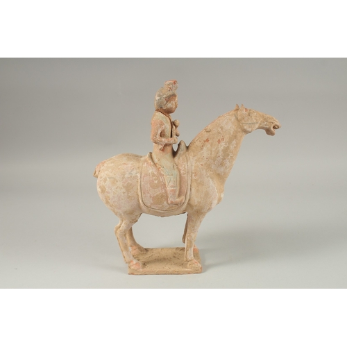 1040 - A TANG POTTERY HORSE AND RIDER, 32cm high.