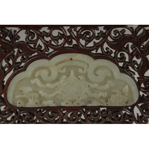 1045 - A PAIR OF SHAPED JADE PLAQUES INSET WITHIN A HARDWOOD FRAME, creating a carved wood table screen, he... 