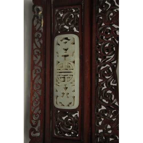 1045 - A PAIR OF SHAPED JADE PLAQUES INSET WITHIN A HARDWOOD FRAME, creating a carved wood table screen, he... 