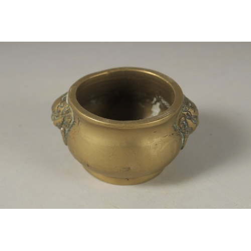 1048 - A MINIATURE 18TH CENTURY BRONZE CENSER, with lion ring handles, 5cm diameter.