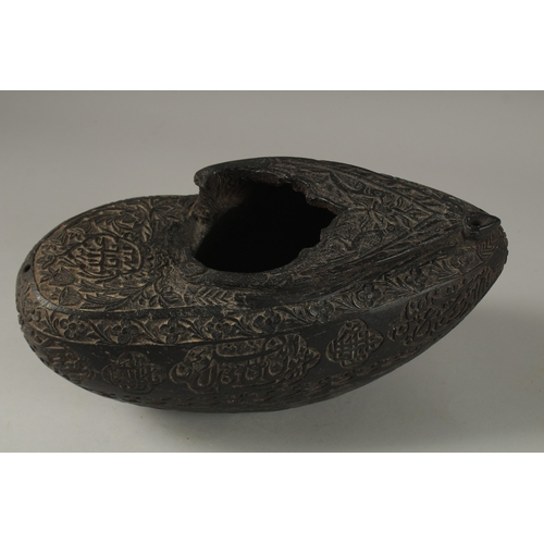 1049 - A SUPERB EXTENSIVELY CARVED COCO DE MER, with Islamic calligraphy, 30cm long, 14cm wide, 11cm deep.