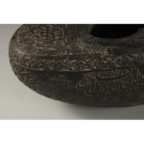 1049 - A SUPERB EXTENSIVELY CARVED COCO DE MER, with Islamic calligraphy, 30cm long, 14cm wide, 11cm deep.