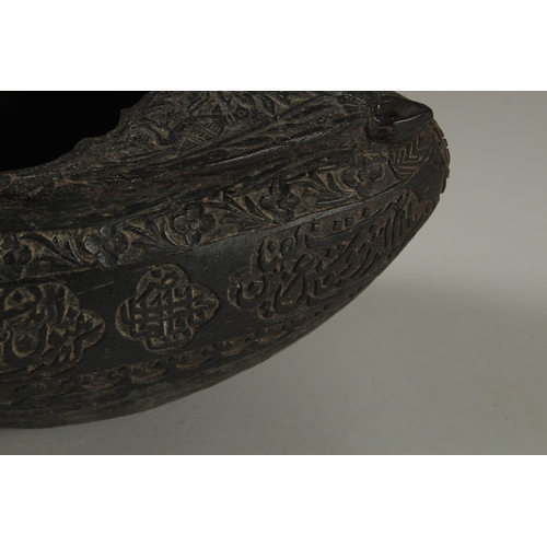 1049 - A SUPERB EXTENSIVELY CARVED COCO DE MER, with Islamic calligraphy, 30cm long, 14cm wide, 11cm deep.