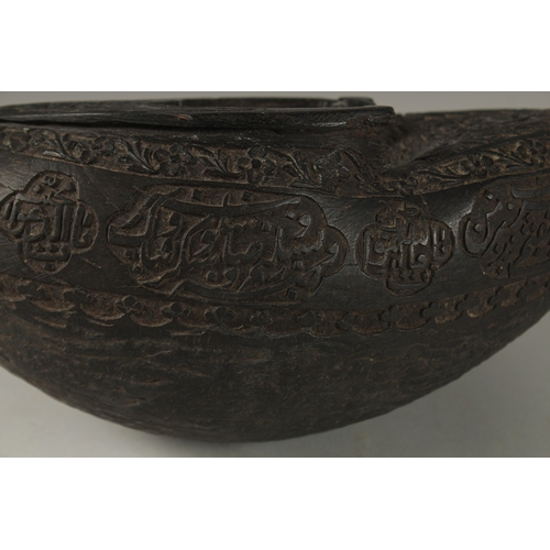 1049 - A SUPERB EXTENSIVELY CARVED COCO DE MER, with Islamic calligraphy, 30cm long, 14cm wide, 11cm deep.