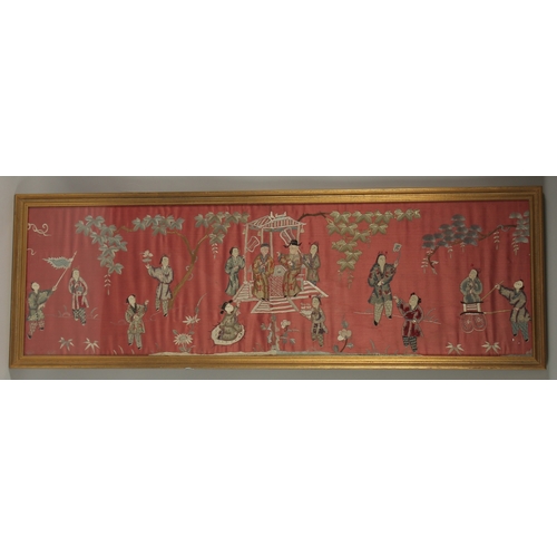 1053 - A LARGE CHINESE EMBROIDERED SILK PANEL, depicting figures, framed and glazed, 33cm x 110cm.