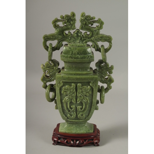 1058 - A LARGE CHINESE CARVED JADE LIDDED VASE, with twin drop ring handles and carved with dog of o, mount... 