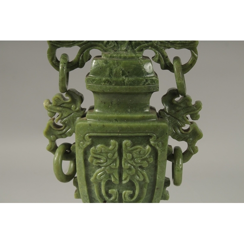 1058 - A LARGE CHINESE CARVED JADE LIDDED VASE, with twin drop ring handles and carved with dog of o, mount... 