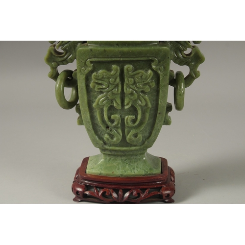 1058 - A LARGE CHINESE CARVED JADE LIDDED VASE, with twin drop ring handles and carved with dog of o, mount... 