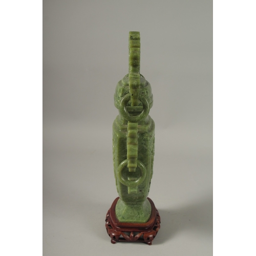 1058 - A LARGE CHINESE CARVED JADE LIDDED VASE, with twin drop ring handles and carved with dog of o, mount... 