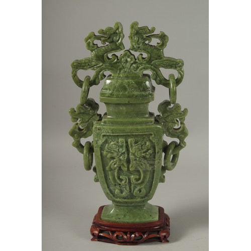 1058 - A LARGE CHINESE CARVED JADE LIDDED VASE, with twin drop ring handles and carved with dog of o, mount... 