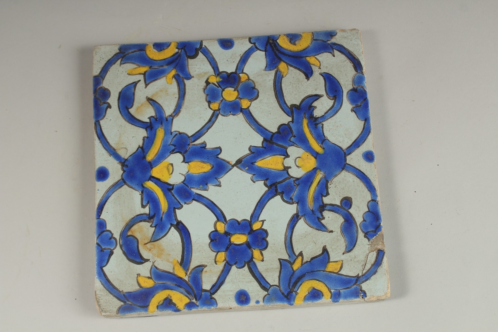 A FINE 18TH19TH CENTURY PERSIAN GLAZED POTTERY TILE, 20cm square.
