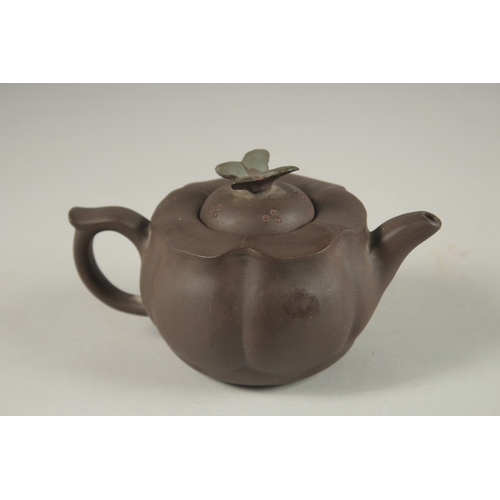 1292 - A CHINESE YIXING TEAPOT, with butterfly finial, impressed mark to inner lid and base.