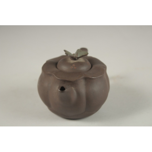 1292 - A CHINESE YIXING TEAPOT, with butterfly finial, impressed mark to inner lid and base.