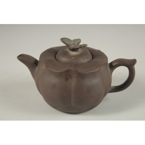 1292 - A CHINESE YIXING TEAPOT, with butterfly finial, impressed mark to inner lid and base.