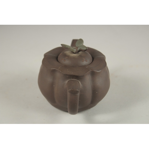 1292 - A CHINESE YIXING TEAPOT, with butterfly finial, impressed mark to inner lid and base.