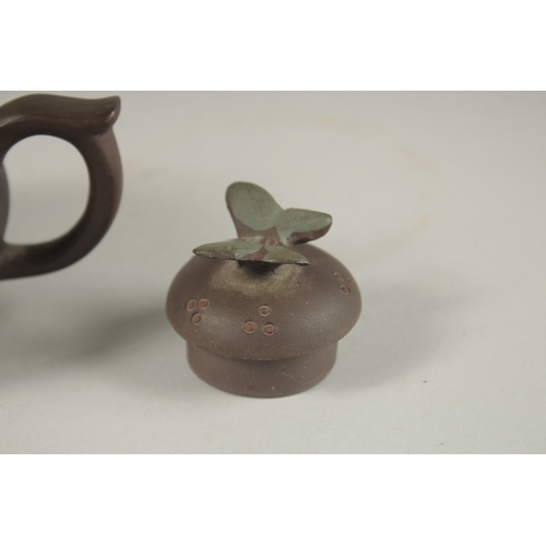 1292 - A CHINESE YIXING TEAPOT, with butterfly finial, impressed mark to inner lid and base.