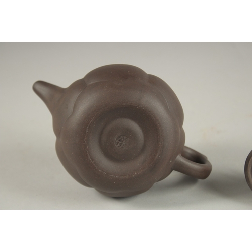 1292 - A CHINESE YIXING TEAPOT, with butterfly finial, impressed mark to inner lid and base.