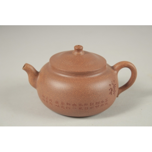 1294 - A CHINESE YIXING TEAPOT, with incised calligraphy, impressed marks to inner lid and base.